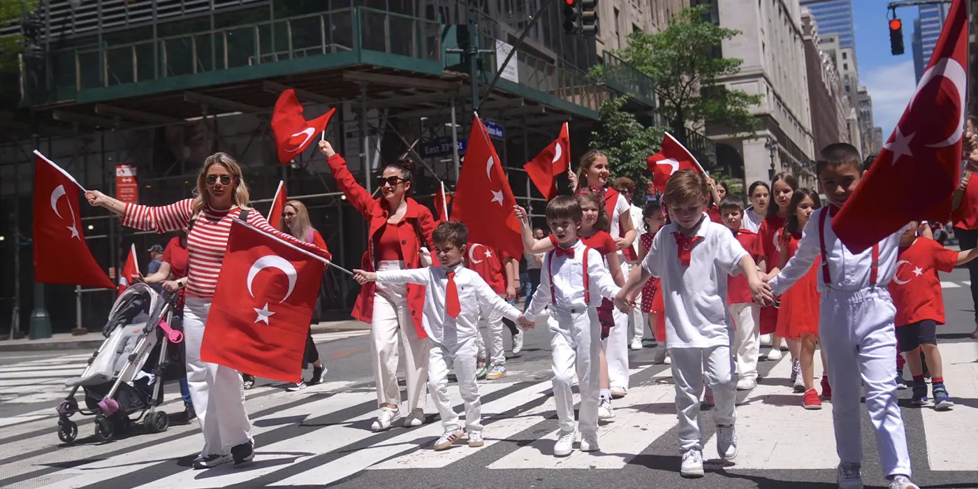 Participants marching in the 42nd Annual Turkish Day Parade in New York, celebrating Turkish culture, music, and community.